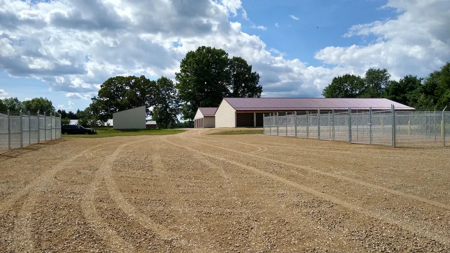 Fenced gravel lot and storage building at My Storage Vestaburg