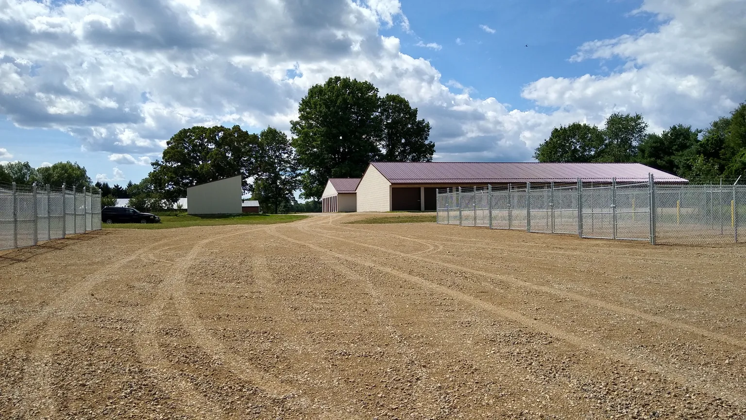 Fenced gravel lot and storage building at My Storage Vestaburg